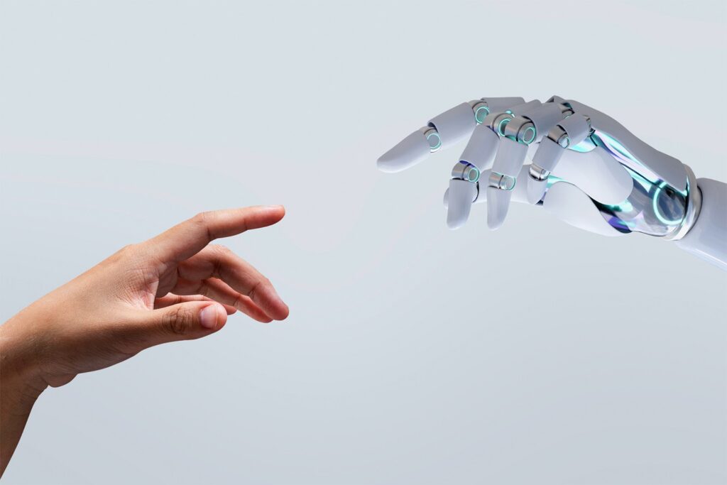 A human hand reaching out to touch the fingertip of a robotic hand, symbolizing the connection between humans and technology—an inspiring image for healthcare marketing prompts—set against a light gray background.